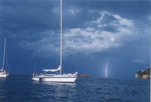 A 42' Jeanneau sits pretty in the lee of a thunderstorm. When it did rain though the crew were below deck with their mariners clothing  well at hand. At sea, as in the mountains, having the right sailing gear especially between seasons is a must.  
