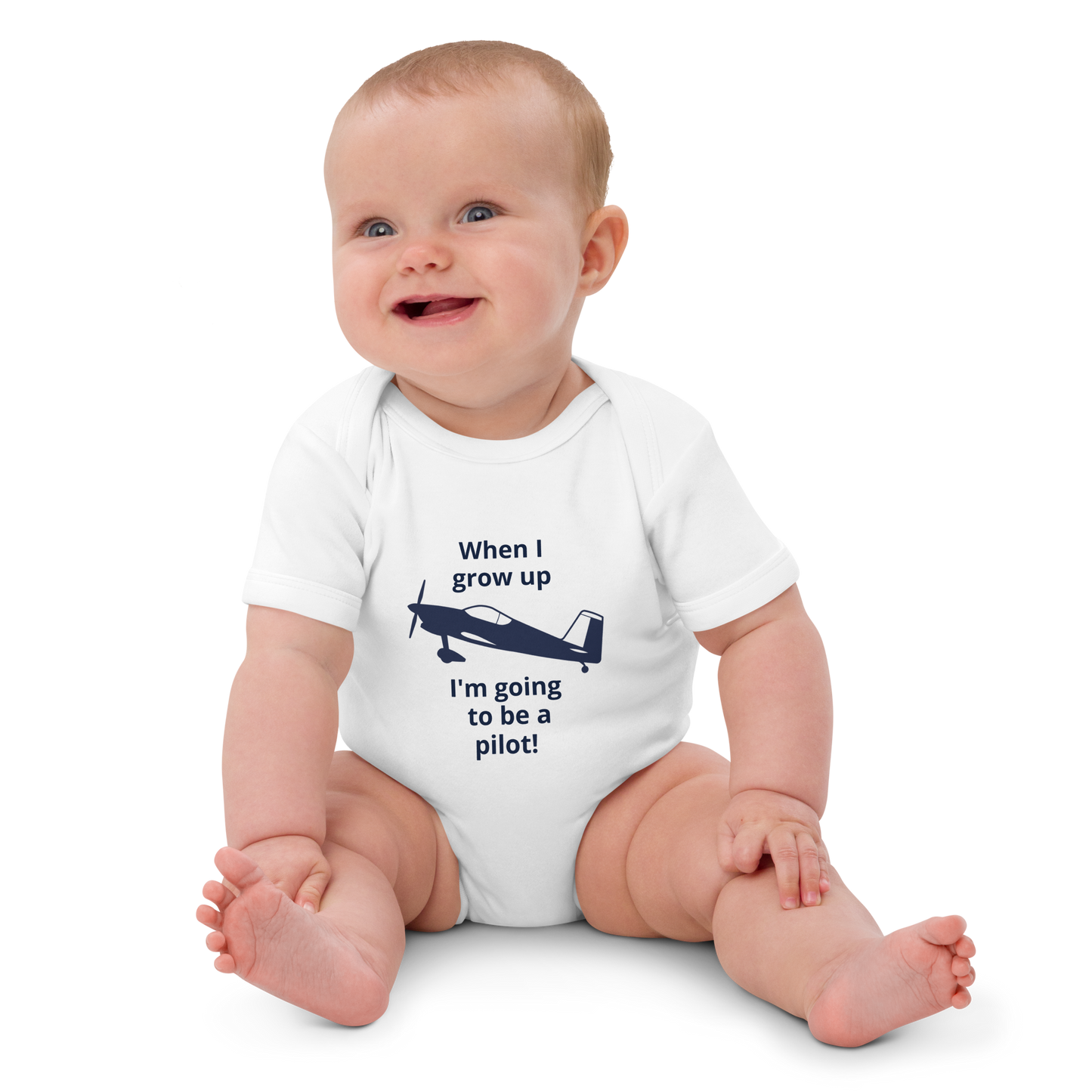 Baby Pilots wear: White cotton baby's bodysuit with an image of a navy blue single prop low wing aircraft surrounded by a sentence that says "when I grow up I'm going to be a pilot!"