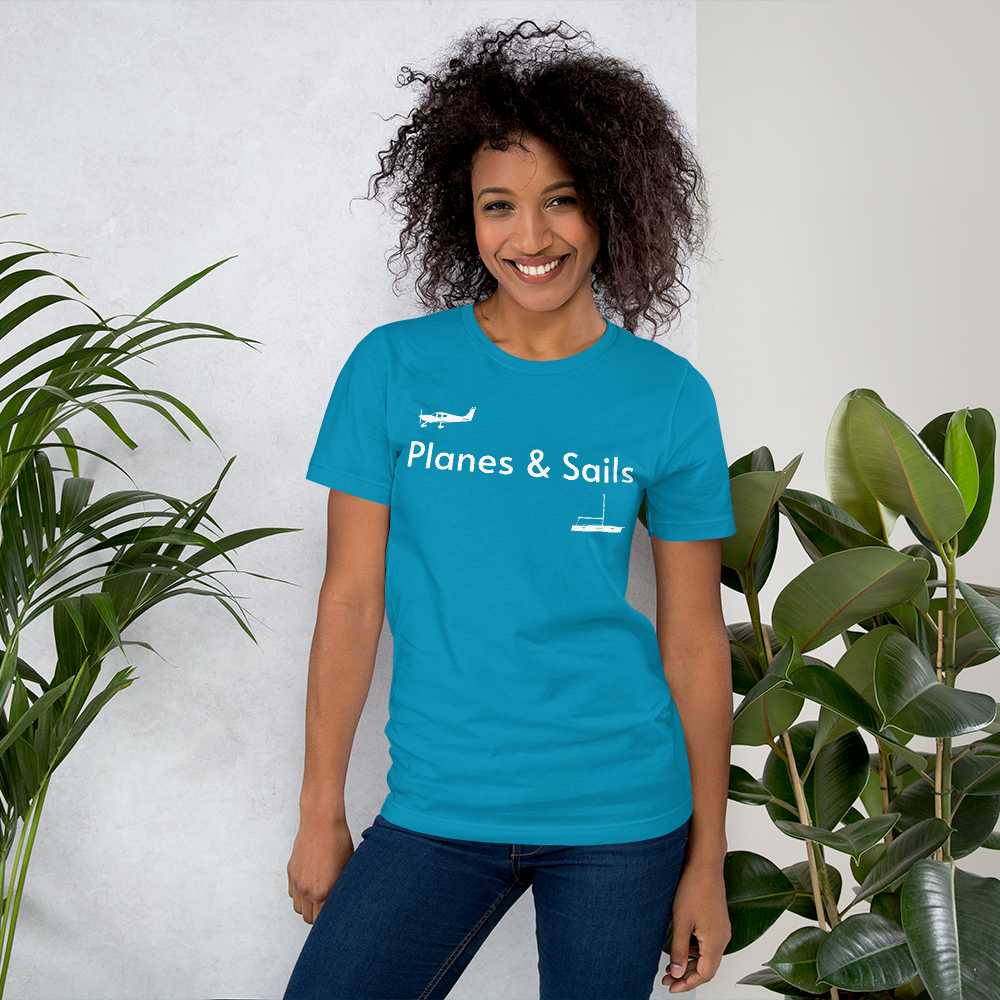 Pilots and mariners clothing: On an aqua coloured tee shirt a white low wing single engine plane is printed on the right breast whereas there is a sailing boat below the left breast with the phrase planes and sails written inbetween the two.