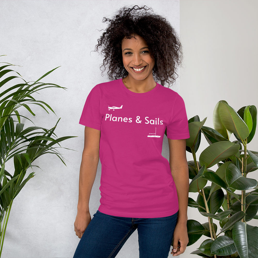 Pilots and mariners clothing: On a berry coloured tee shirt a white low wing single engine plane is printed on the right breast whereas there is a sailing boat below the left breast with the phrase planes and sails written inbetween the two.