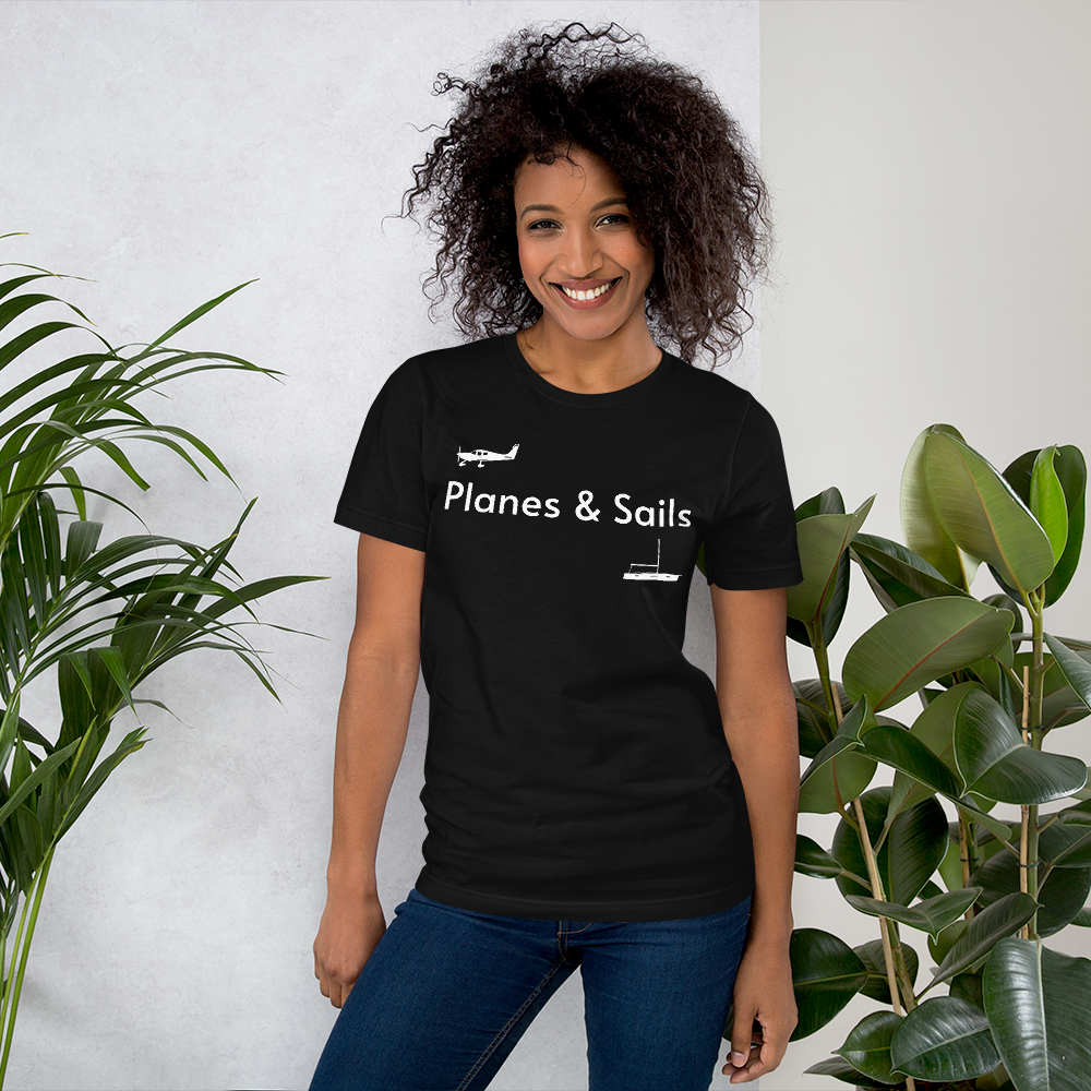 Pilots and mariners clothing: On a black coloured tee shirt a white low wing single engine plane is printed on the right breast whereas there is a sailing boat below the left breast with the phrase planes and sails written inbetween the two.