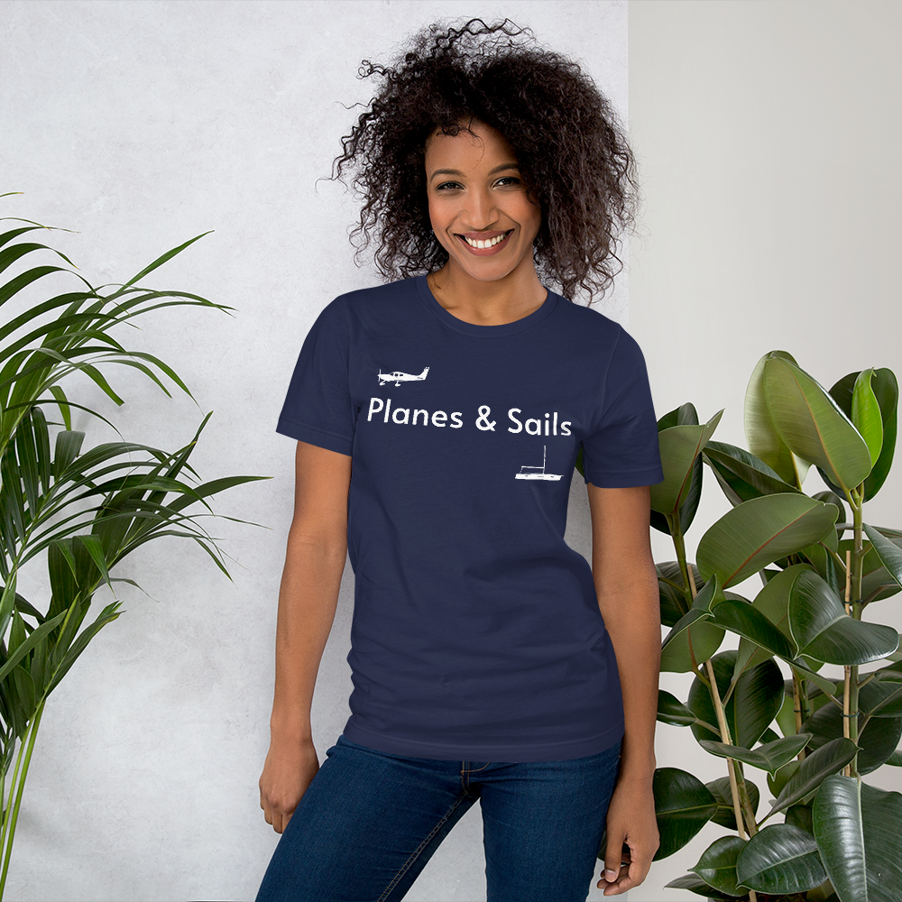 Pilots and mariners clothing: On a navy blue coloured tee shirt a white low wing single engine plane is printed on the right breast whereas there is a sailing boat below the left breast with the phrase planes and sails written inbetween the two.