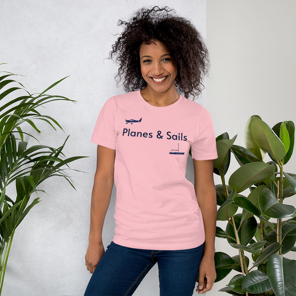 Pilots and mariners clothing: On a pink coloured tee shirt a navy blue low wing single engine plane is printed on the right breast whereas there is a sailing boat below the left breast with the phrase planes and sails written inbetween the two.