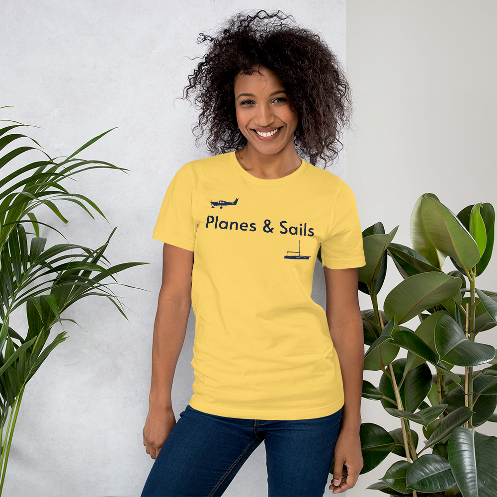 Pilots and mariners clothing: On a yellow coloured tee shirt a navy blue low wing single engine plane is printed on the right breast whereas there is a sailing boat below the left breast with the phrase planes and sails written inbetween the two.