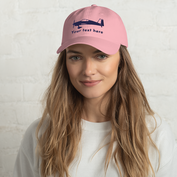 Pilots apparel: Pink baseball cap with and embroidered customizable navy blue image of a Vans RV 7 aircraft.