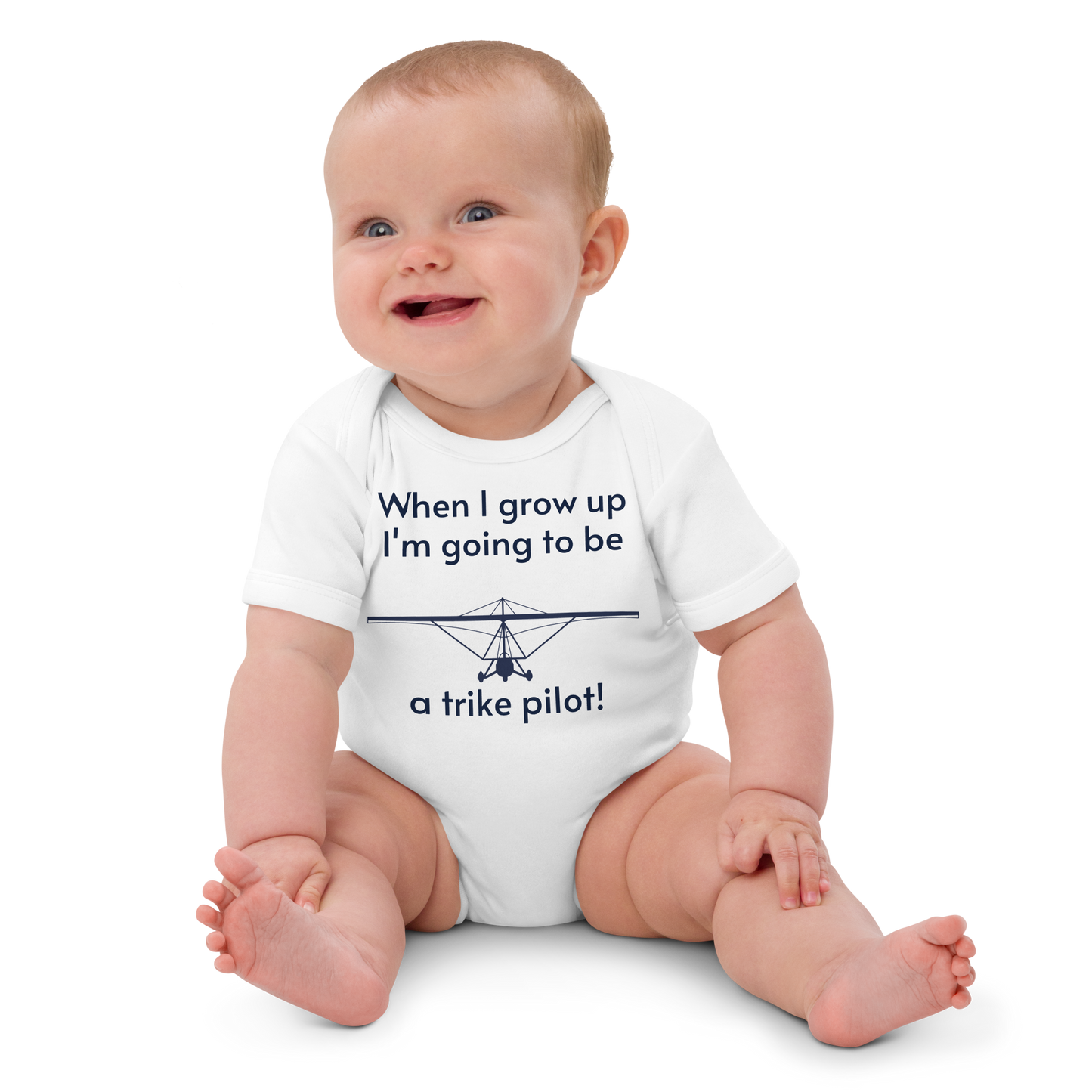 Baby Pilots wear: White cotton baby's bodysuit with an image of a navy blue weight shift aircraft surrounded by a sentence that says "when I grow up i'm going to be a trike pilot!"