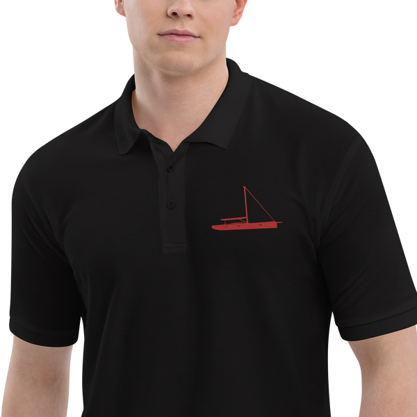 Sailing apparel: Black polo shirt depicting a red sailing boat placed over the left breast.