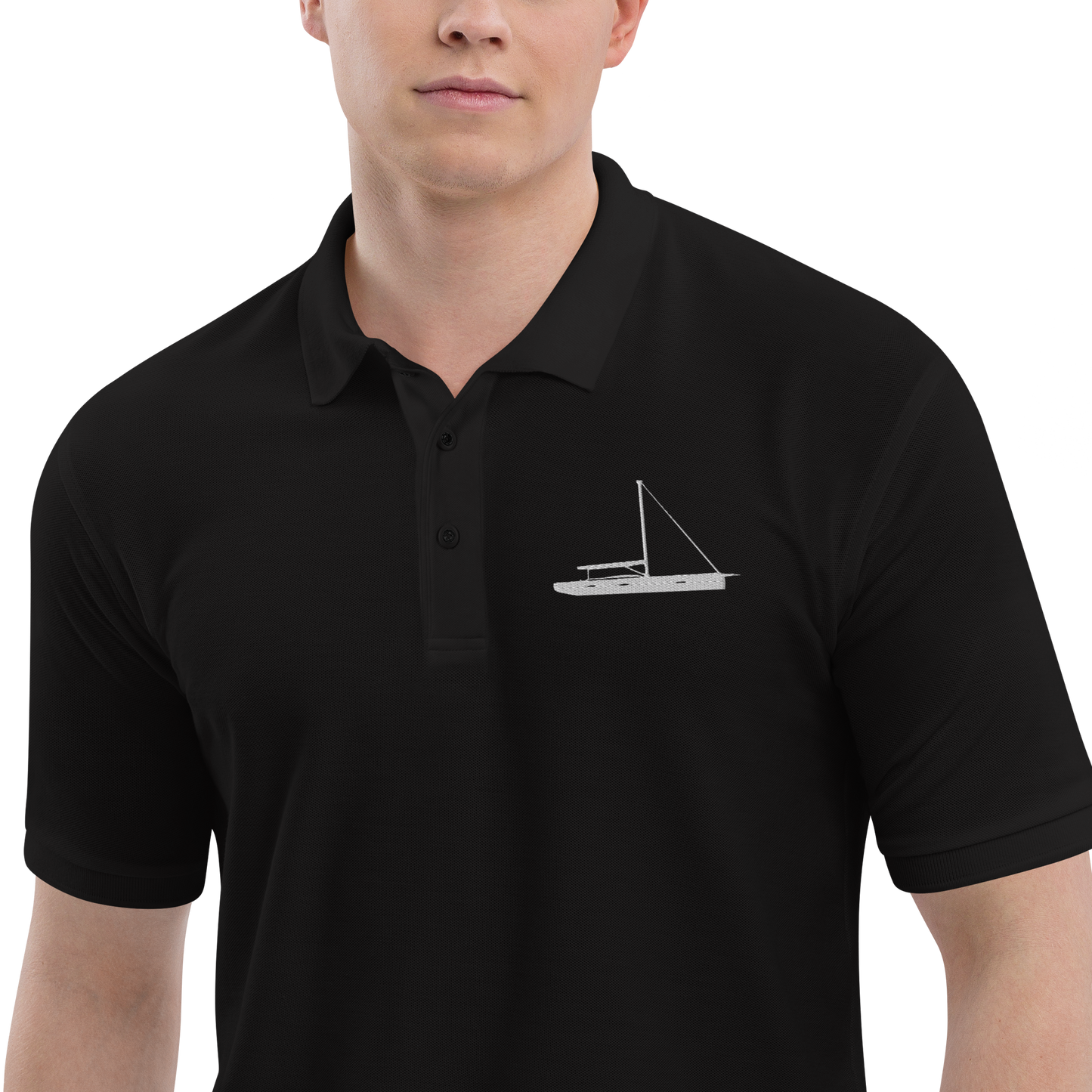 Sailing apparel: Black polo shirt depicting a white embroidered sailing boat placed over the left breast.