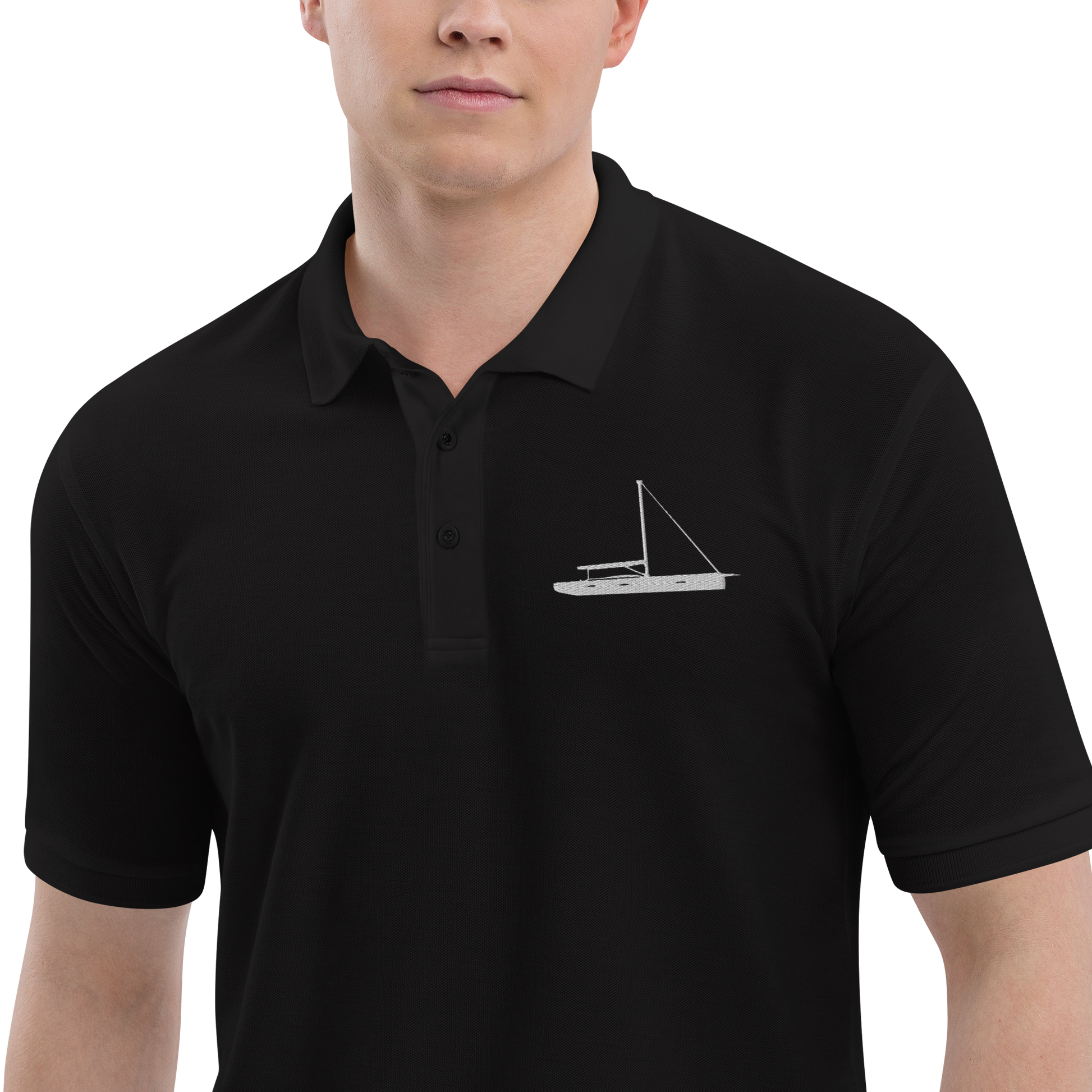 Sailing apparel: Black polo shirt depicting a white embroidered sailing boat placed over the left breast.