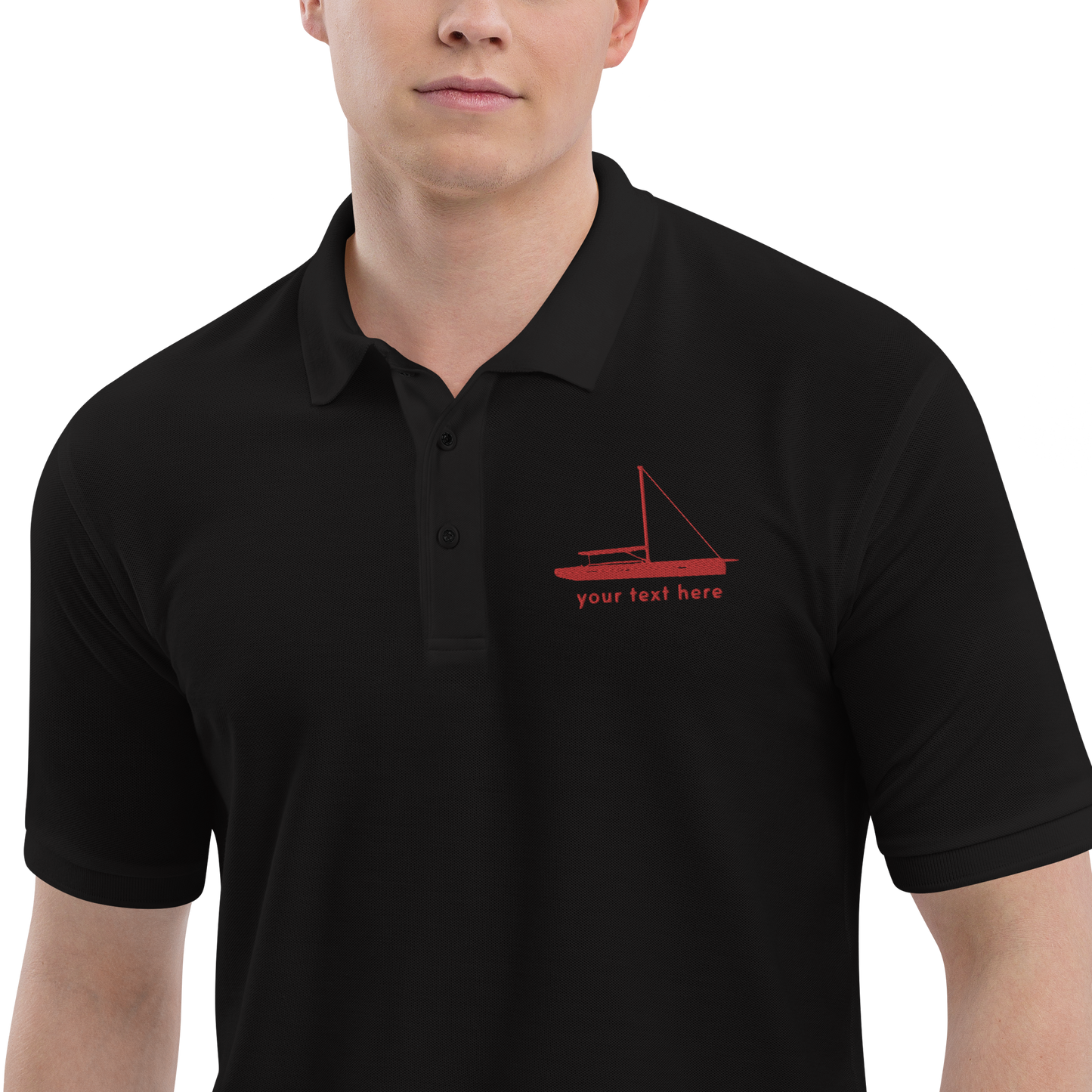 Sailing apparel: Black polo shirt with a red sloop rigged sailing boat placed over the left breast.