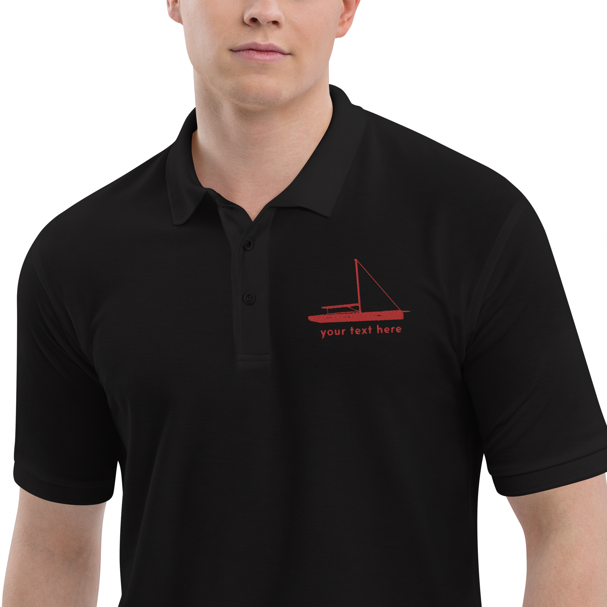 Sailing apparel: Black polo shirt with a red sloop rigged sailing boat placed over the left breast.