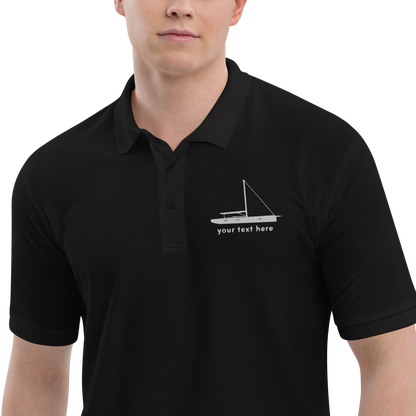 Sailing apparel: Black polo shirt with a white sloop rigged sailing boat placed over the left breast.