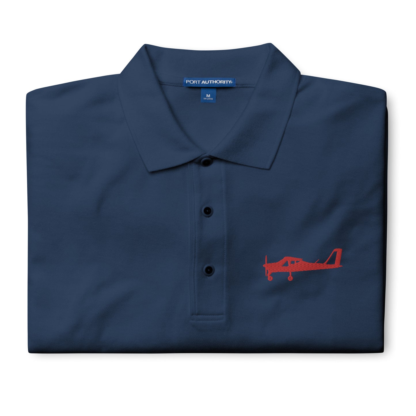 Red Tecnam P92 aircraft embroidered design placed on the left breast of a navy blue colour polo shirt.