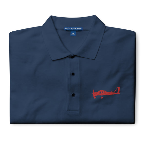 Red Tecnam P92 aircraft embroidered design placed on the left breast of a navy blue colour polo shirt.