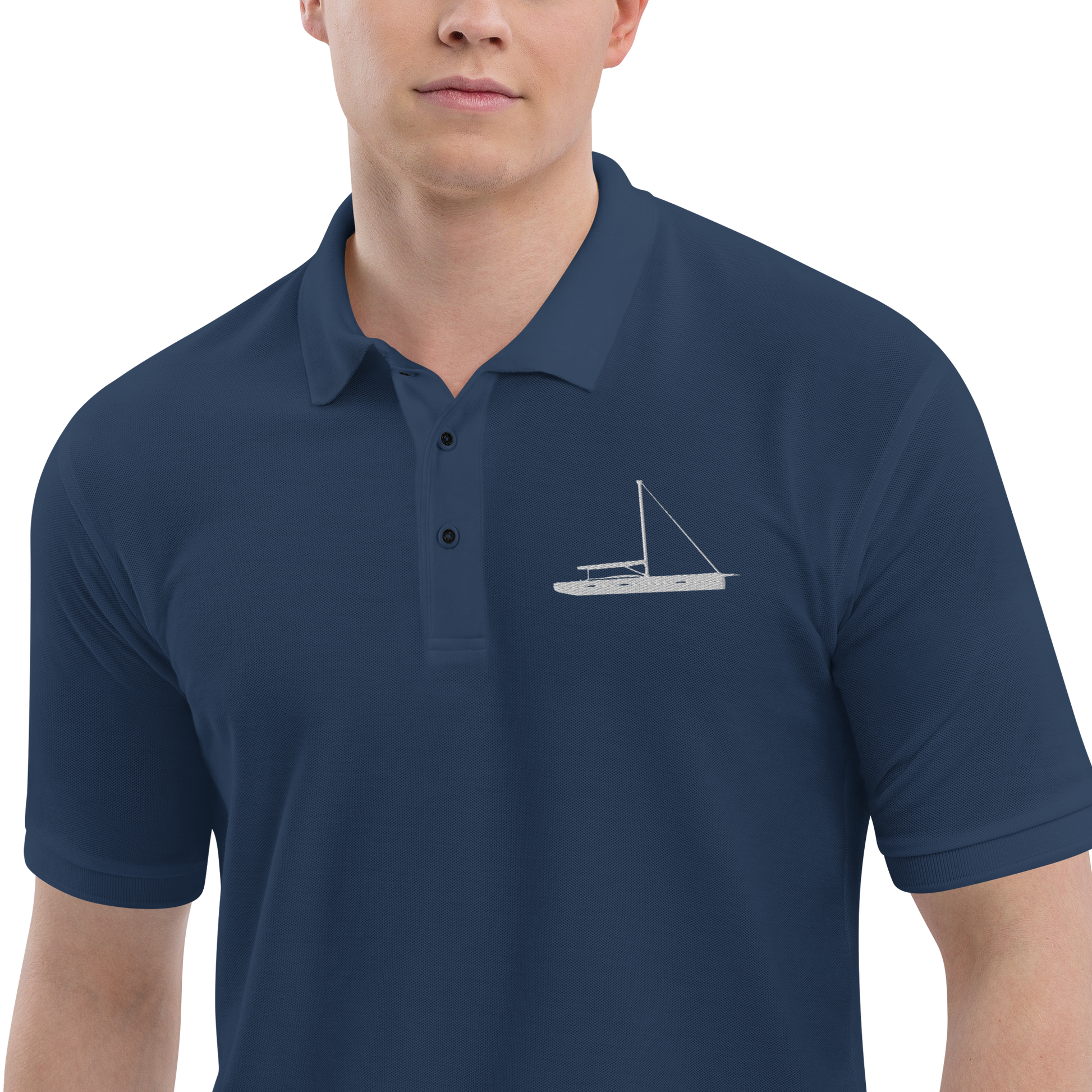 Sailing apparel: Navy blue polo shirt depicting a white embroidered sailing boat placed over the left breast.