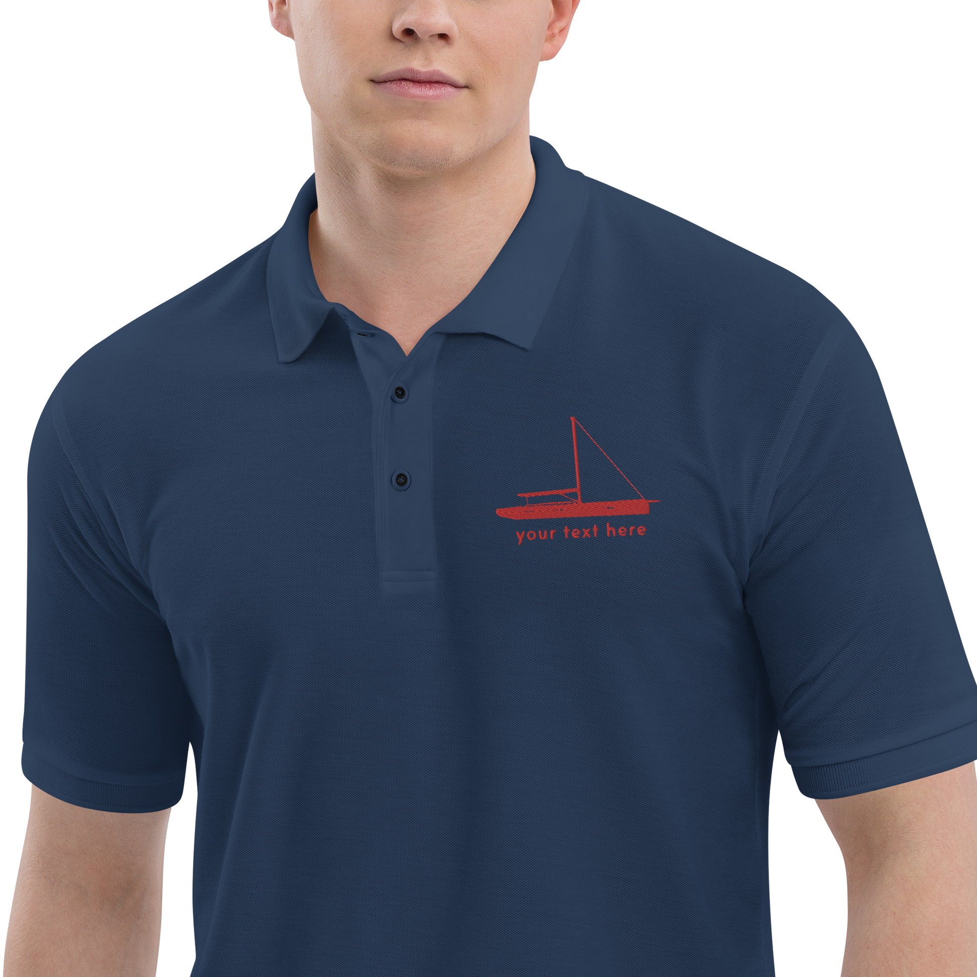 Sailing apparel: Navy blue polo shirt with a red sloop rigged sailing boat placed over the left breast.