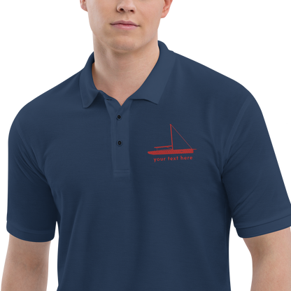 Sailing apparel: Navy blue polo shirt with a red sloop rigged sailing boat placed over the left breast.