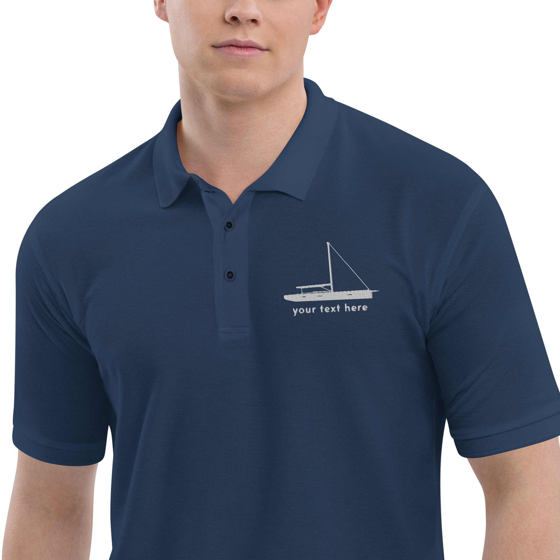 Sailing apparel: Navy blue polo shirt with a white sloop rigged sailing boat placed over the left breast.