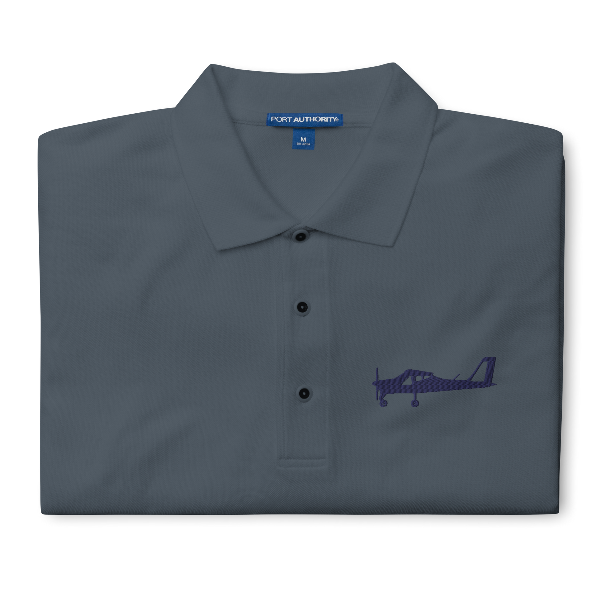 Navy blue Tecnam P92 aircraft embroidered design placed on the left breast of a dark grey polo shirt.