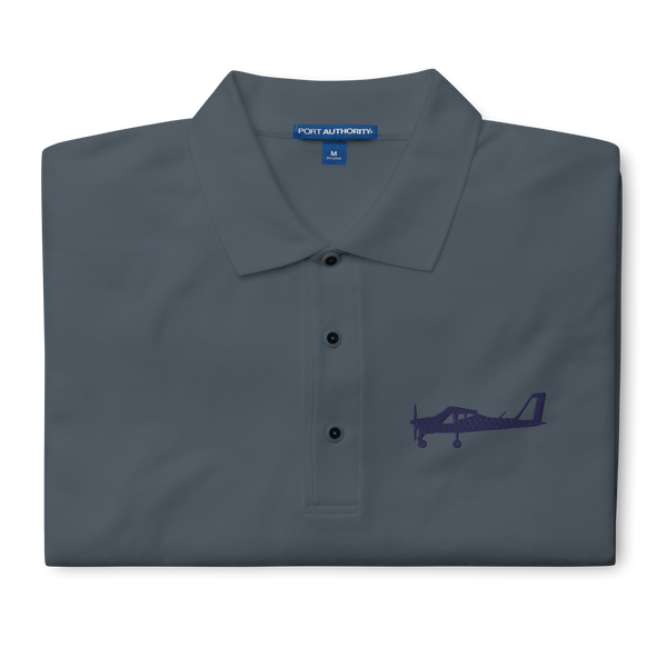 Navy blue Tecnam P92 aircraft embroidered design placed on the left breast of a dark grey polo shirt.