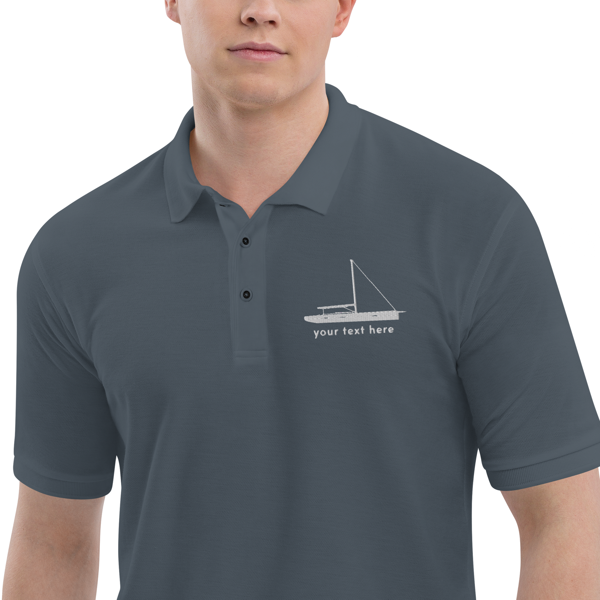 Sailing apparel: Asphalt grey polo shirt with a white sloop rigged sailing boat placed over the left breast.