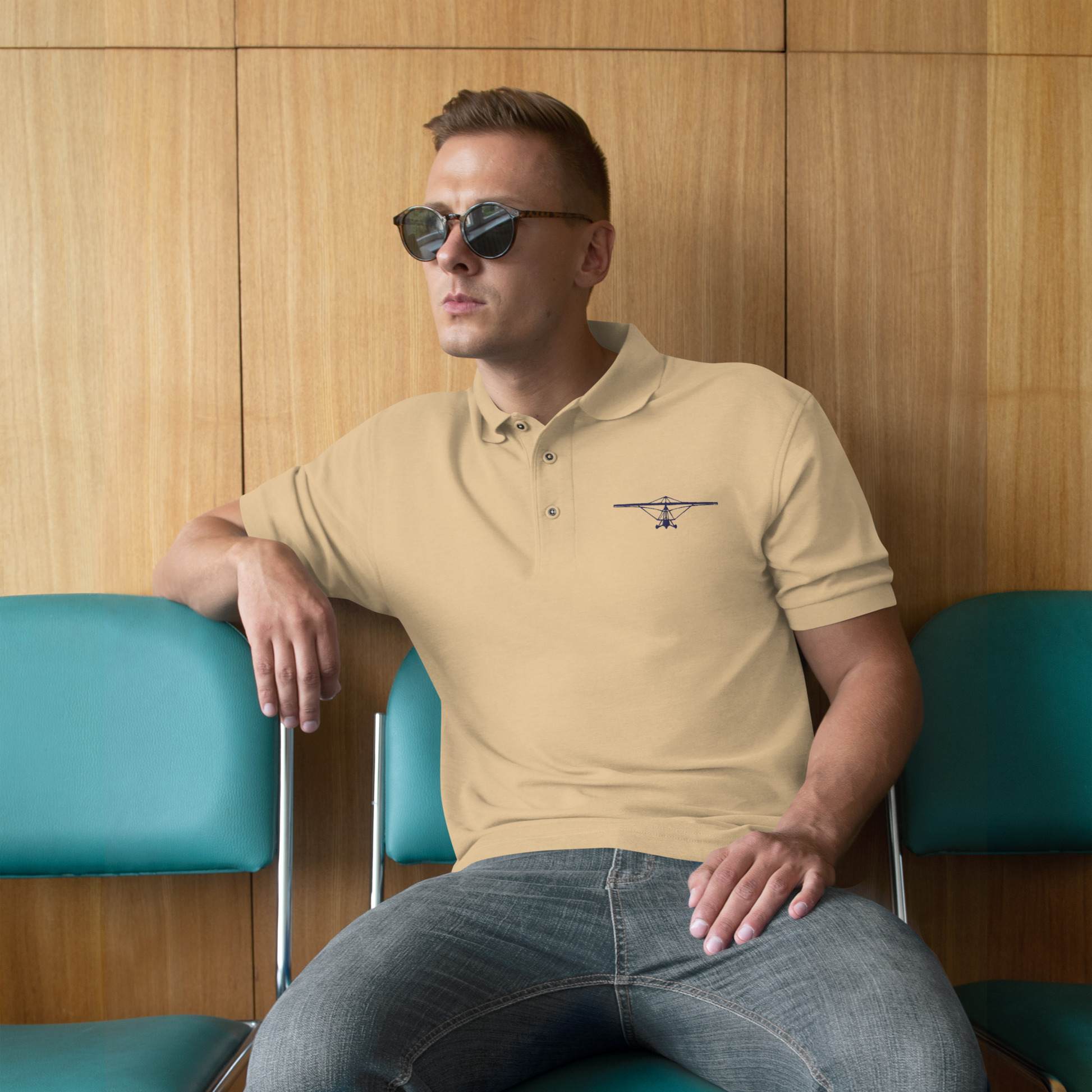 Pilot Shirts: Navy blue embroidered weight shift aircraft design placed on the left breast of a beige polo shirt.