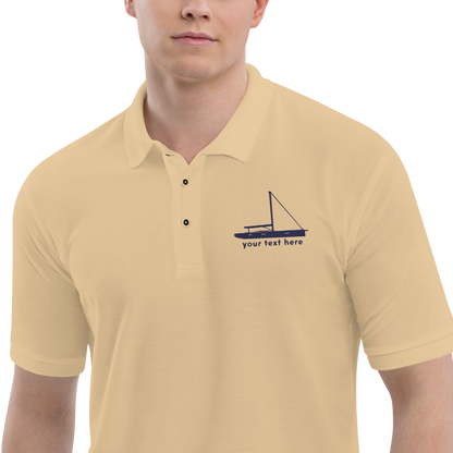 Sailing apparel: Beige polo shirt with a navy blue sloop rigged sailing boat placed over the left breast.