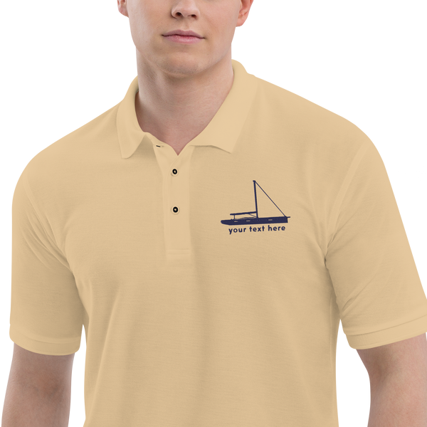 Sailing apparel: Beige polo shirt with a navy blue sloop rigged sailing boat placed over the left breast.