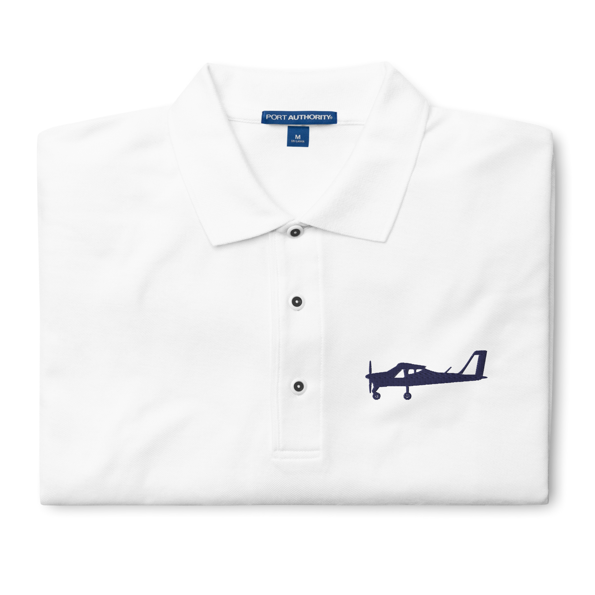 Navy blue Tecnam P92 aircraft embroidered design placed on the left breast of a white colour polo shirt.