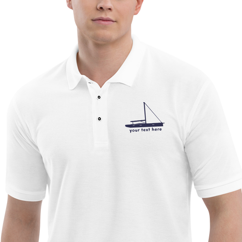 Sailing apparel: White polo shirt with a navy blue sloop rigged sailing boat placed over the left breast.