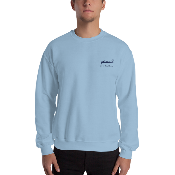 Navy blue Tecnam P92 aircraft customizable design placed on the left breast of a light blue sweatshirt