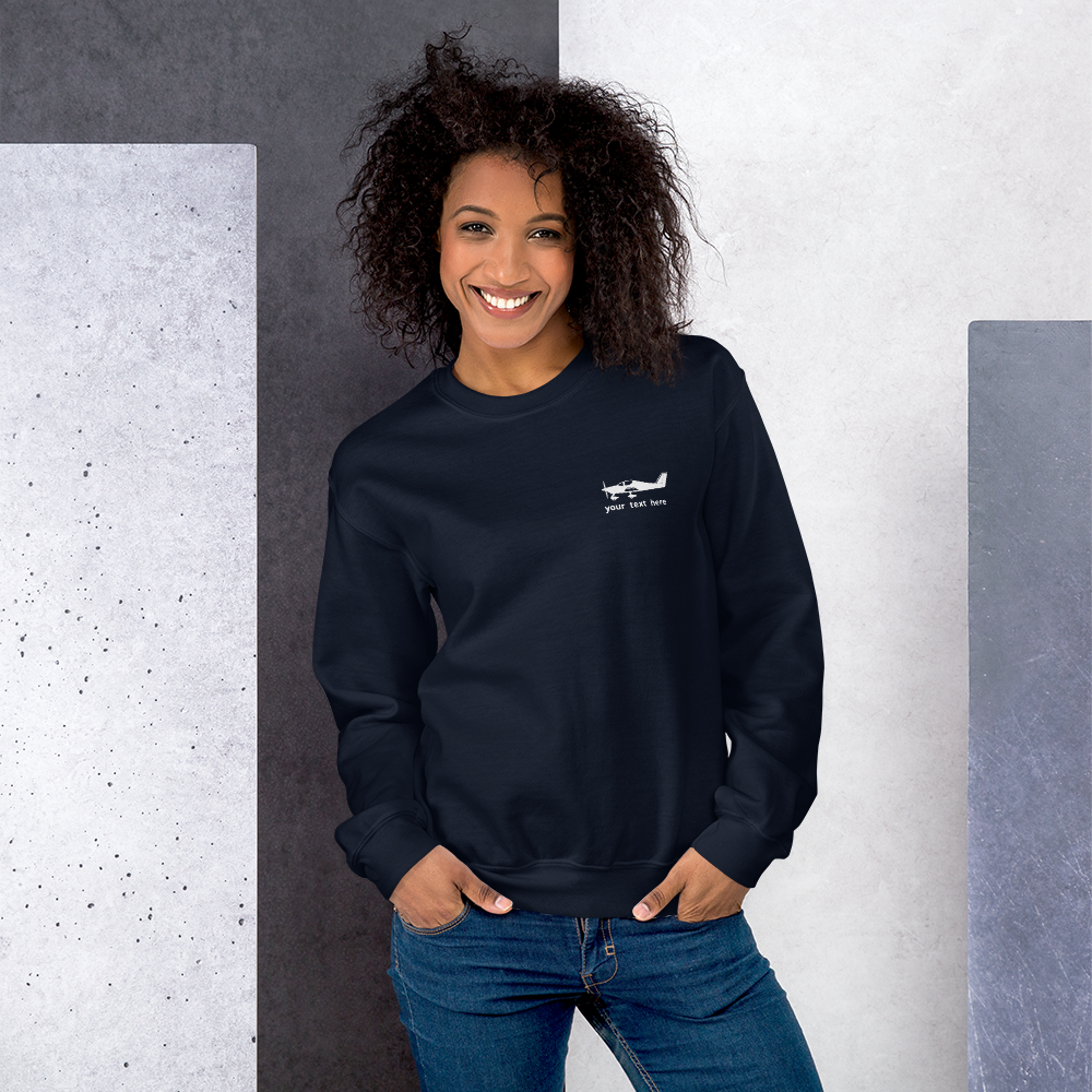 White Astore aircraft customizable design placed on the left breast of a navy blue sweatshirt