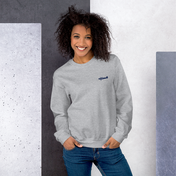 Pilots sweaters: navy blue Super Cub design positioned on the left breast of a light grey sweatshirt.